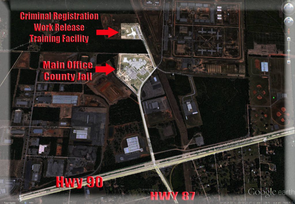 Aerial view of a correctional facility complex with labeled buildings, intersected by highways 90 and 87.