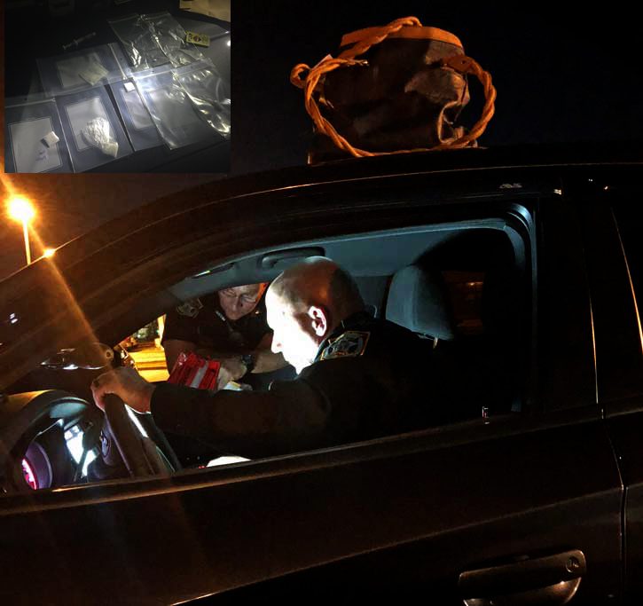 A police officer interacts with a driver at a nighttime vehicle stop, with a view of evidence bags and a mask inset above.